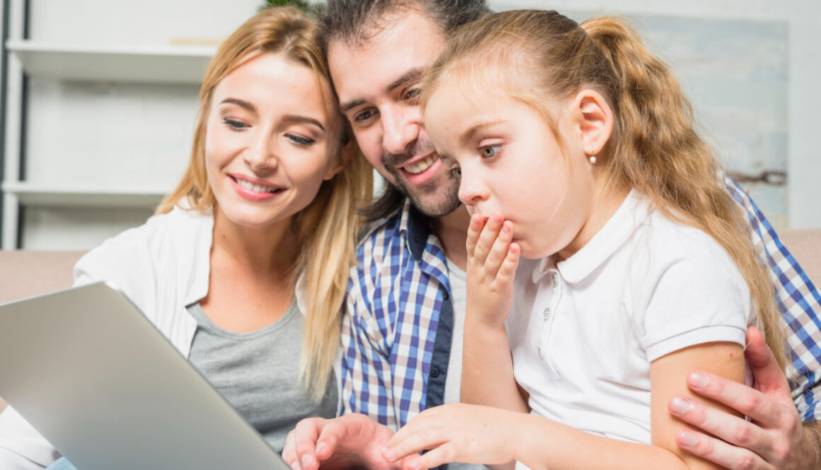 family-using-laptop-sofa