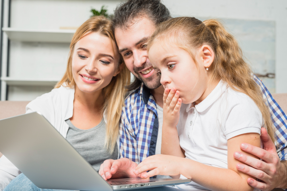 family-using-laptop-sofa