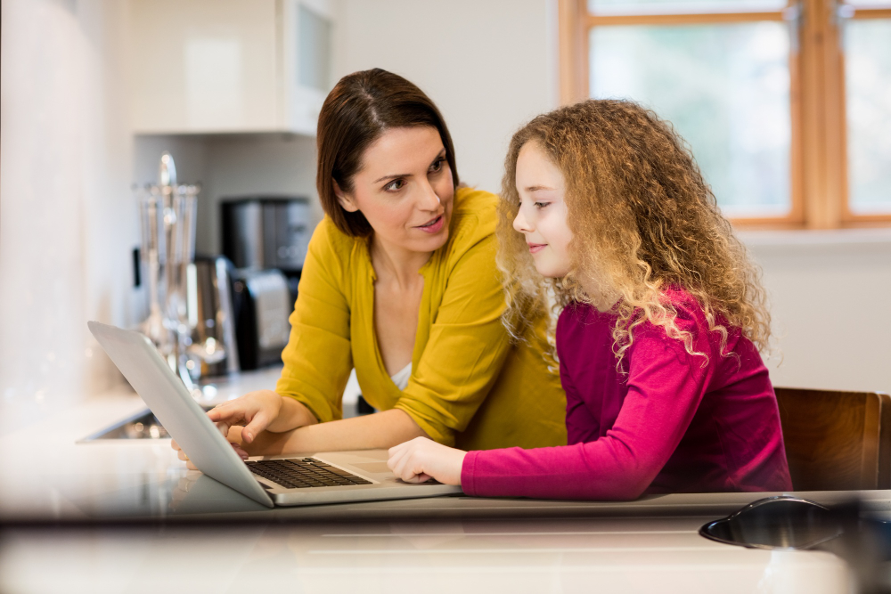 mother-daughter-using-laptop-kitchen